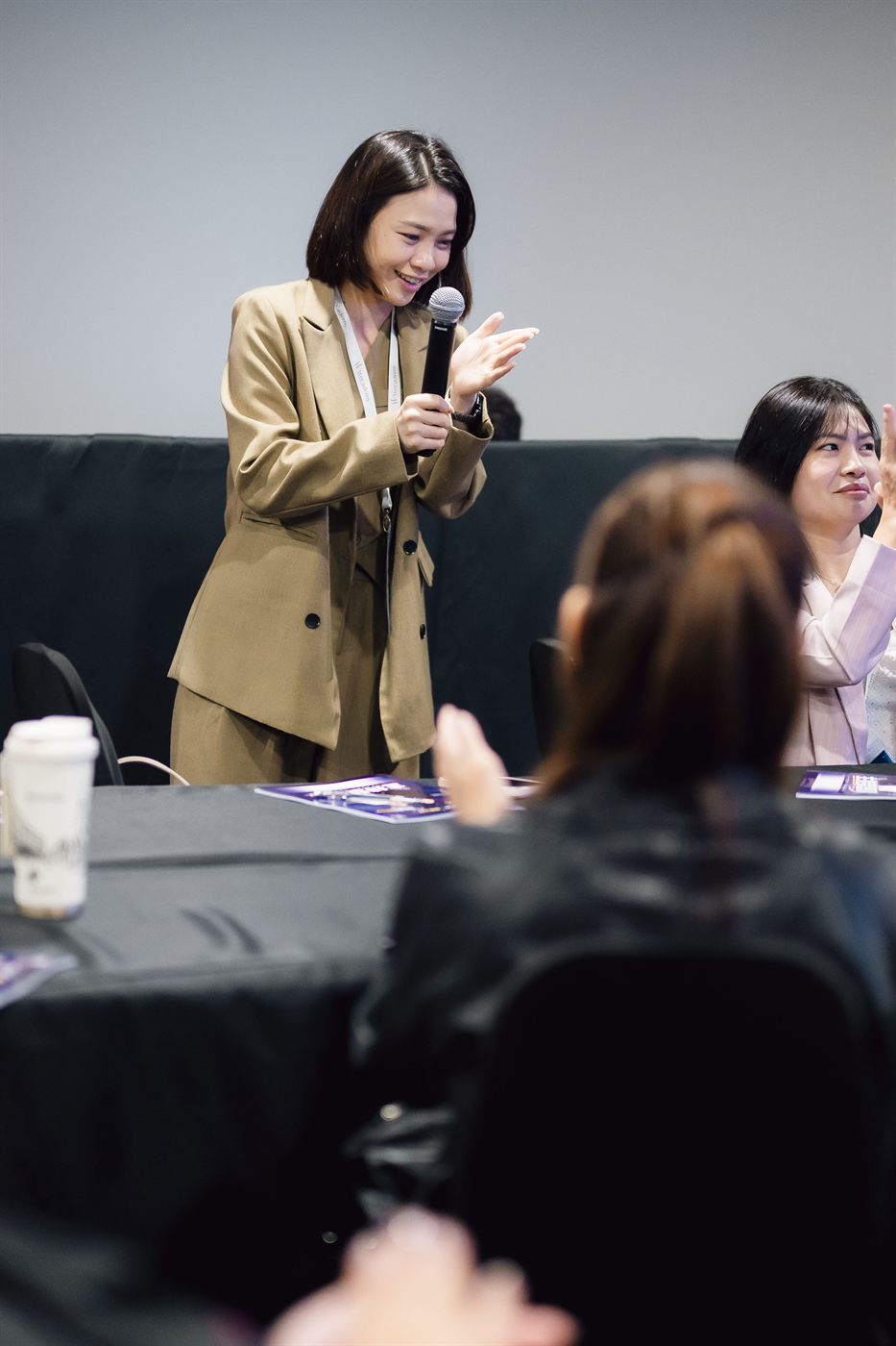 Yen engaging the audience with a smile